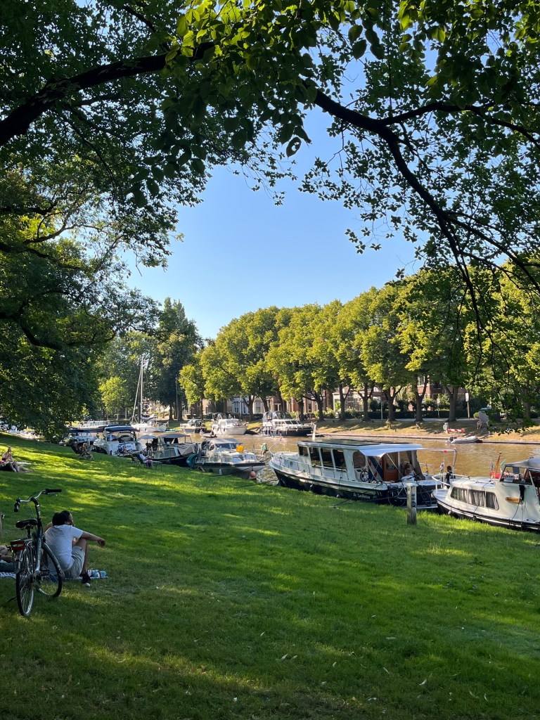 Pretty park in summer with dutch canal and boats