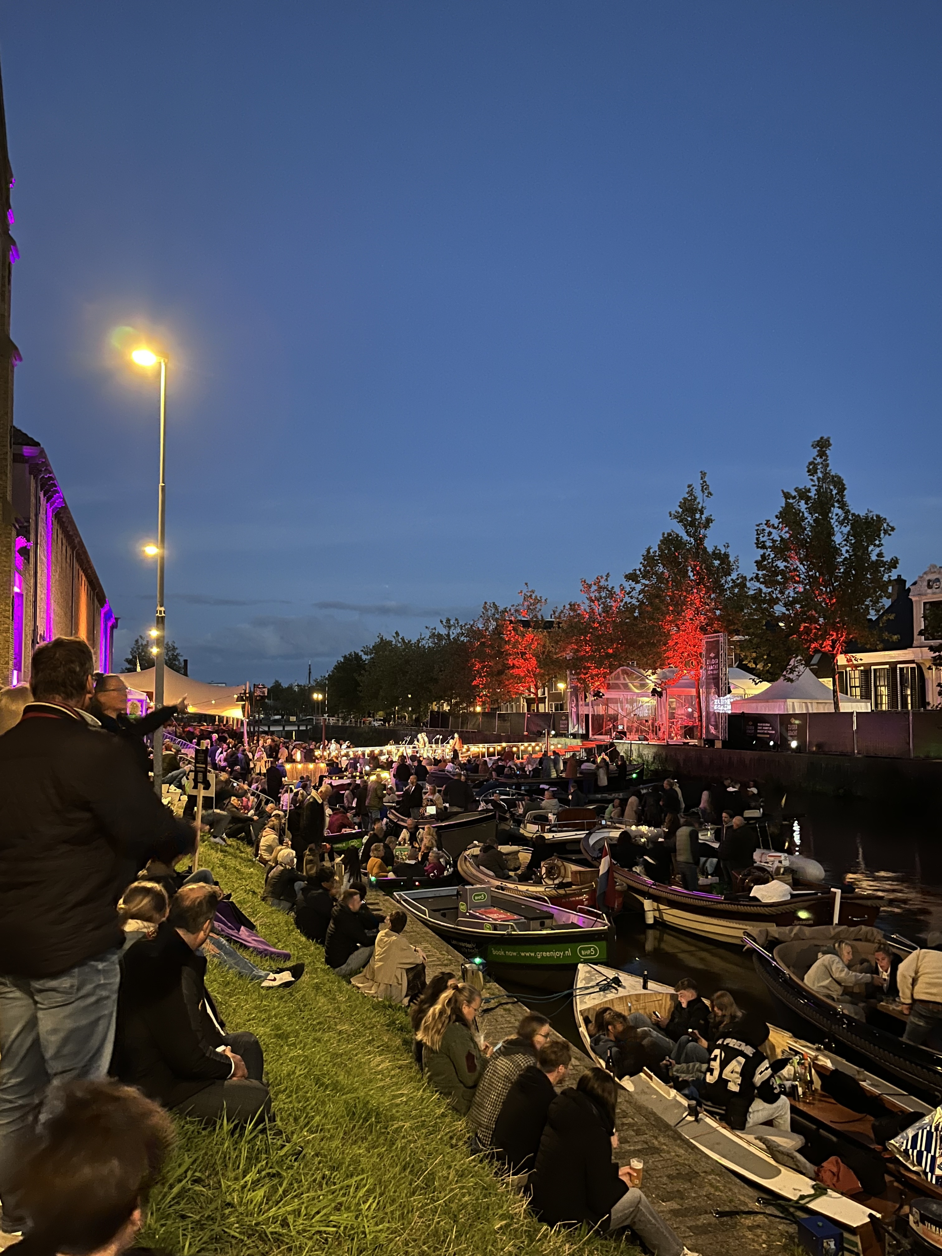 People in the dutch canal on boats enjoying concert